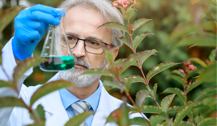 an image of a scientist doing experiment outdoors