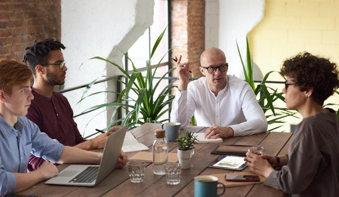 People having a meeting at work and discussing various topics