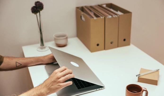 A person closing a laptop and reducing screen time for brain optimization