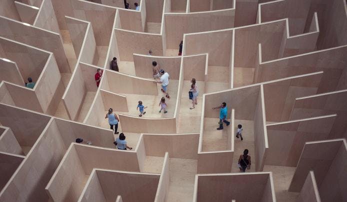 an image of people going through a maze