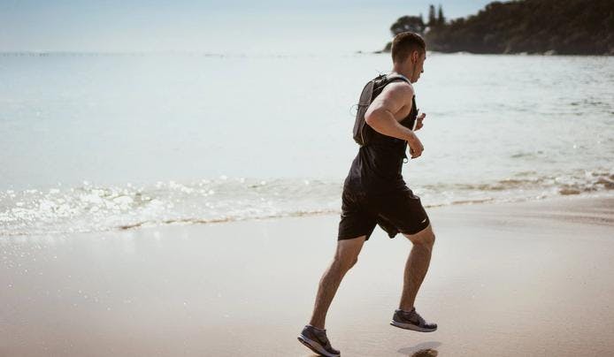 an image of a person running on the beach