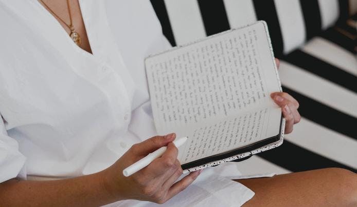 A women reading her journal to develop existential intelligence