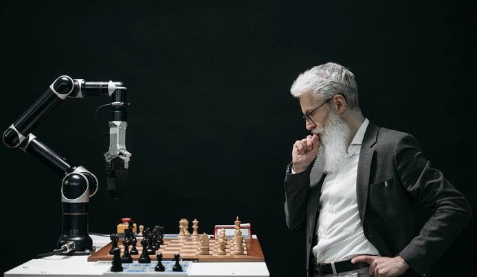 an image of a robot playing chess with a men