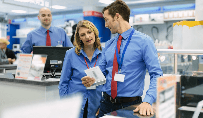 Store manager talking to employees