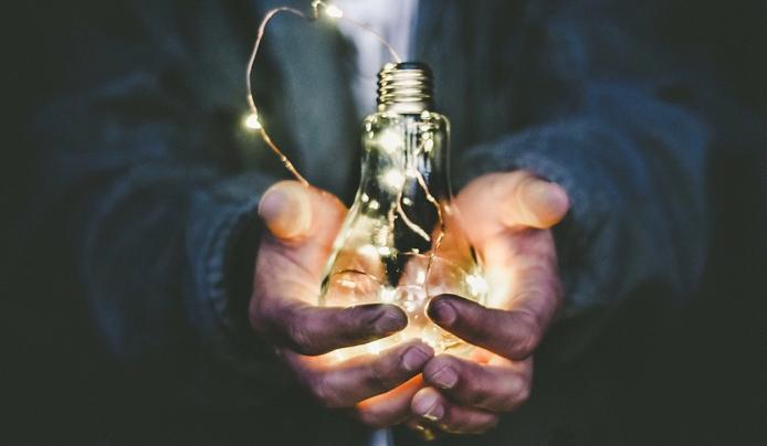 an image of a person holding a light bulb