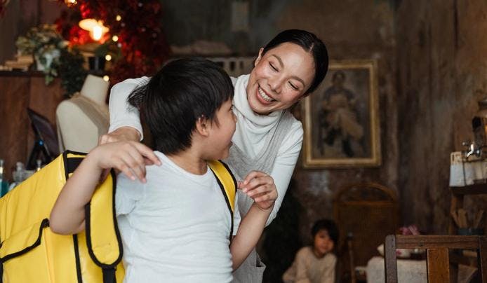 an image of a woman hugging a boy